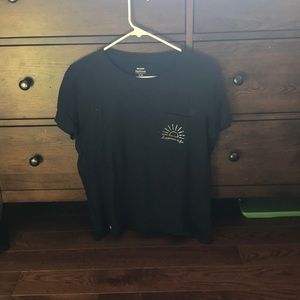 navy blue shirt with words “happiness is free”